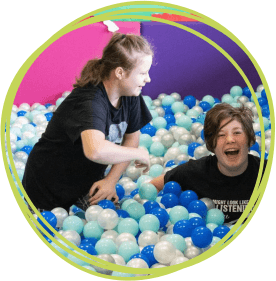 siblings in the soft play ball pool